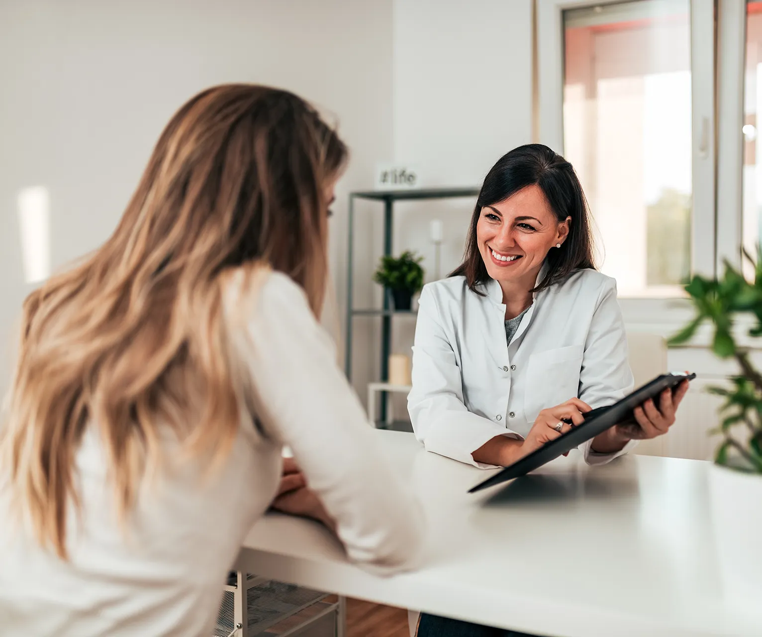 Doctor consulting with a patient in a modern office.