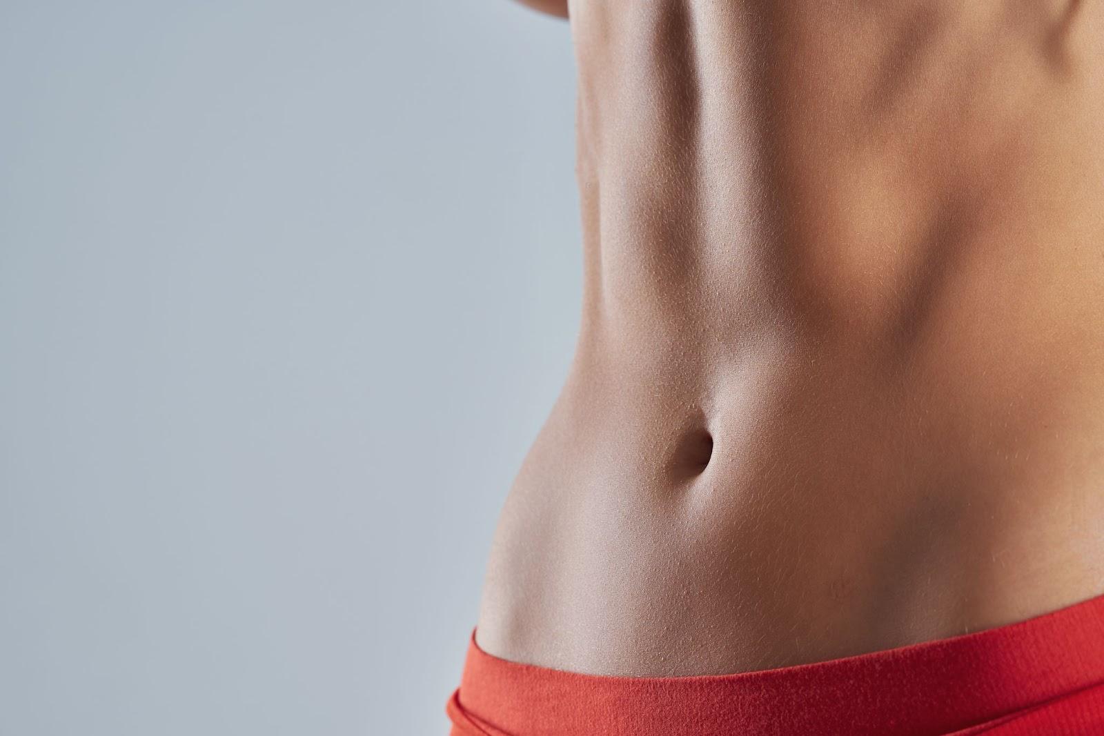 Close-up view of a woman’s stomach.